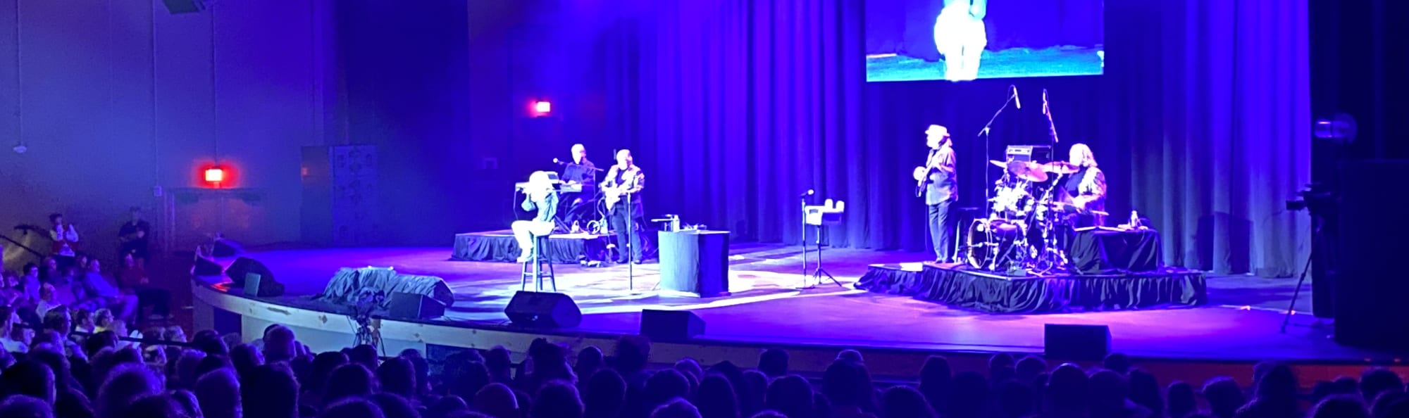 signer on stage in chair washed out by the lights Lincoln